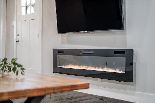 interior details featuring a glass covered fireplace