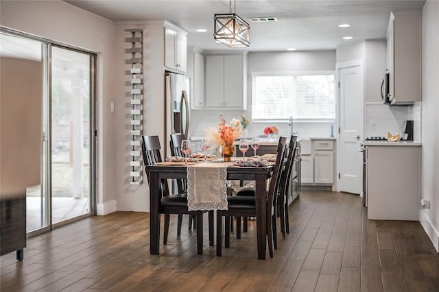 dining room with recessed lighting, visible vents, and dark wood finished floors