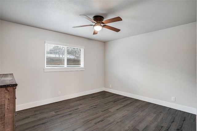 unfurnished room featuring dark wood-style floors, baseboards, and a ceiling fan