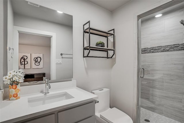 full bath with toilet, a shower stall, and vanity