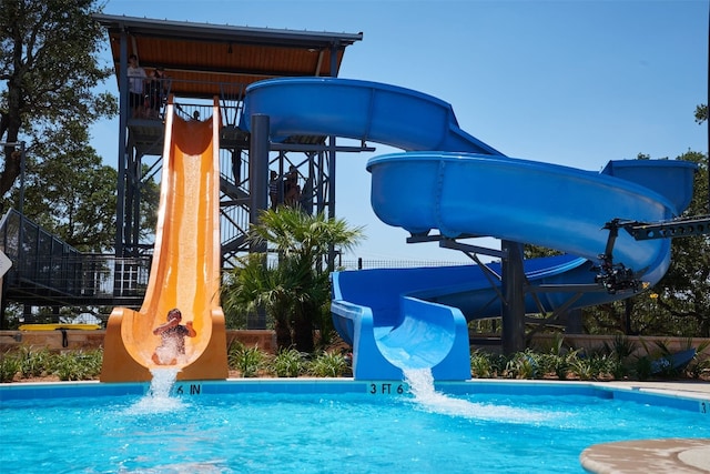 outdoor pool with a water slide