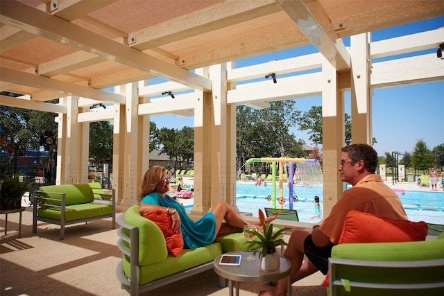 view of patio / terrace with a community pool and a pergola