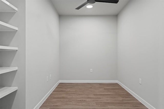 unfurnished room with baseboards, a ceiling fan, and wood finished floors