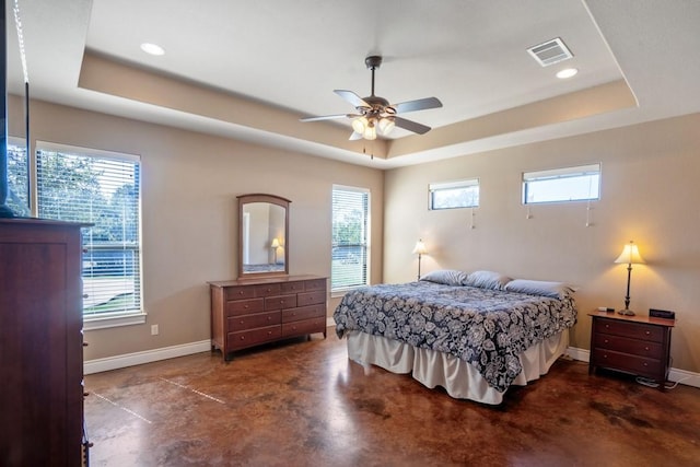 bedroom with visible vents, a raised ceiling, and concrete flooring