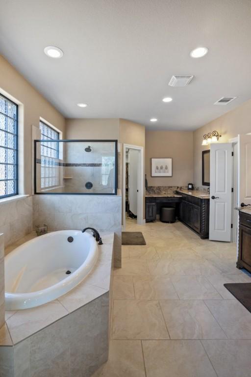 bathroom featuring visible vents, tiled shower, vanity, a bath, and recessed lighting