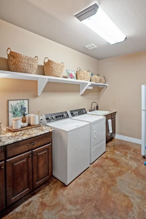 laundry room with independent washer and dryer, a sink, cabinet space, and baseboards