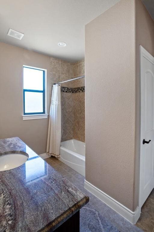 bathroom with visible vents, baseboards, tile patterned flooring, shower / bath combination with curtain, and vanity