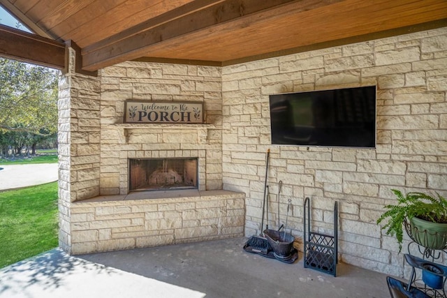 view of patio with an outdoor stone fireplace