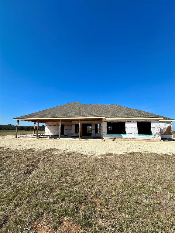 back of property featuring an outdoor structure and an exterior structure