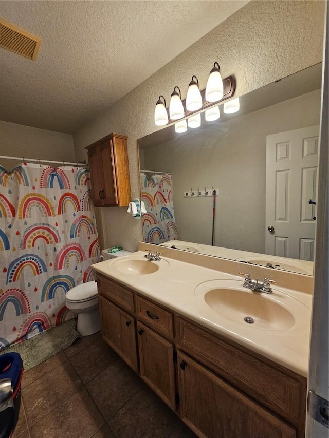 full bathroom featuring visible vents, a sink, a textured ceiling, and double vanity