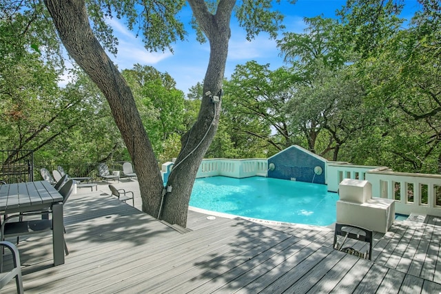 exterior space with a deck and a fenced in pool