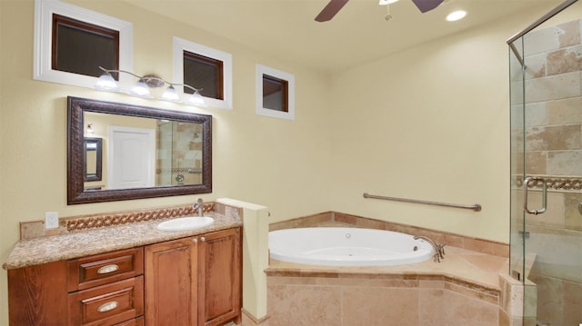 full bathroom featuring a stall shower, a garden tub, ceiling fan, and vanity