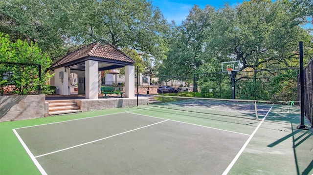 view of tennis court with a gazebo and fence