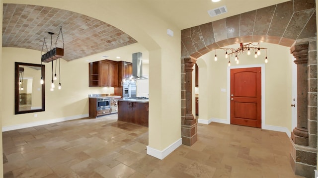 entryway featuring brick ceiling, baseboards, and arched walkways