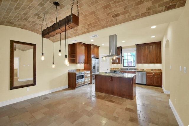 kitchen with recessed lighting, island range hood, stainless steel appliances, baseboards, and brick ceiling