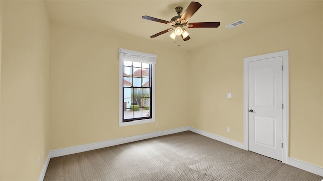 empty room featuring carpet floors, baseboards, and visible vents