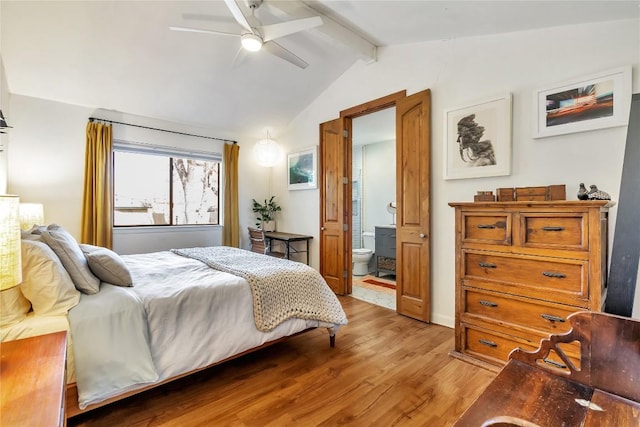 bedroom with lofted ceiling with beams, light wood-style floors, a ceiling fan, and ensuite bathroom