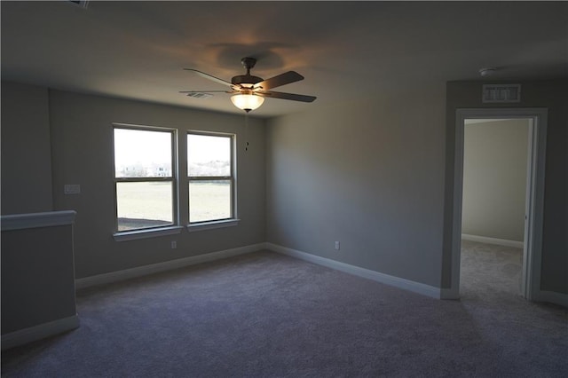 unfurnished room with ceiling fan, carpet flooring, visible vents, and baseboards