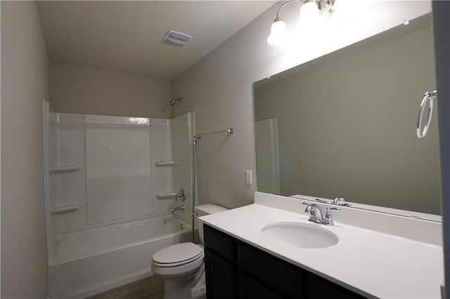 bathroom featuring visible vents, toilet, wood finished floors, vanity, and washtub / shower combination