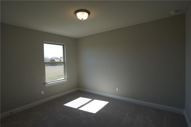 carpeted spare room with baseboards