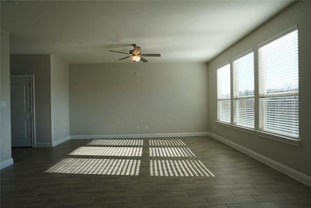 unfurnished room featuring wood finished floors, a ceiling fan, and baseboards