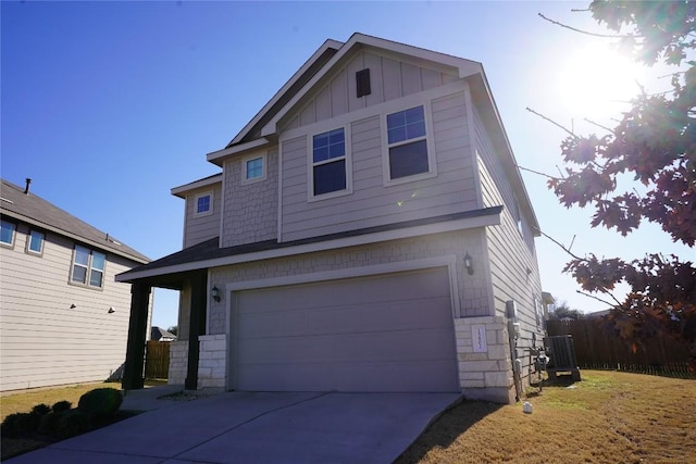 traditional-style home featuring board and batten siding, concrete driveway, and an attached garage