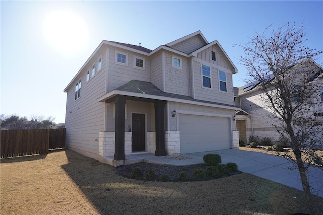 craftsman inspired home with board and batten siding, concrete driveway, fence, and a garage