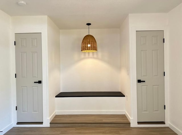 interior space with wood finished floors and baseboards