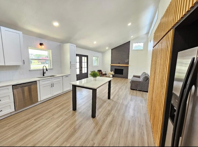 kitchen with dishwasher, light countertops, french doors, white cabinetry, and a sink