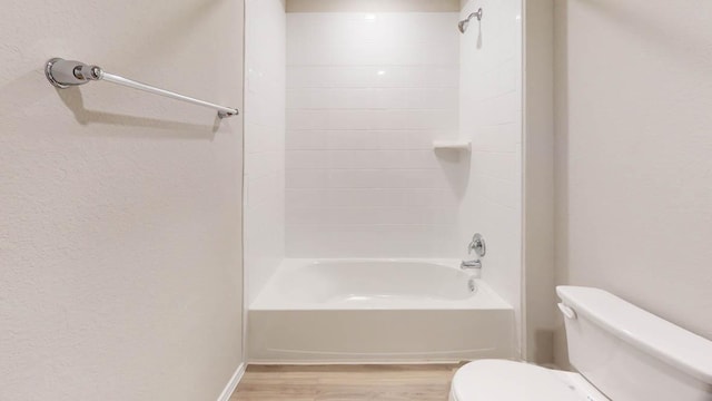 full bathroom with shower / bath combination, toilet, and wood finished floors