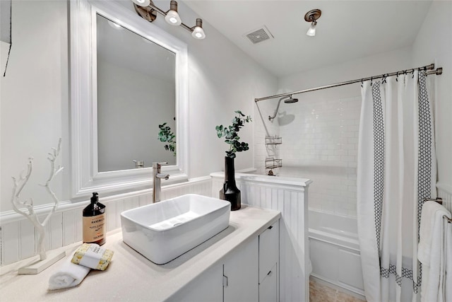 8102 Baywood Dr Unit A, Austin, TX 78759 - bathroom with vanity, shower / bathtub combination with curtain, and wainscoting