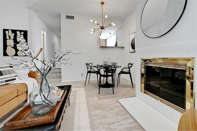 8102 Baywood Dr Unit A, Austin, TX 78759 - living area featuring stacked washer and clothes dryer, light wood-style flooring, and a chandelier