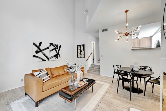 8102 Baywood Dr Unit A, Austin, TX 78759 - living room with light wood-type flooring, a chandelier, and stairs