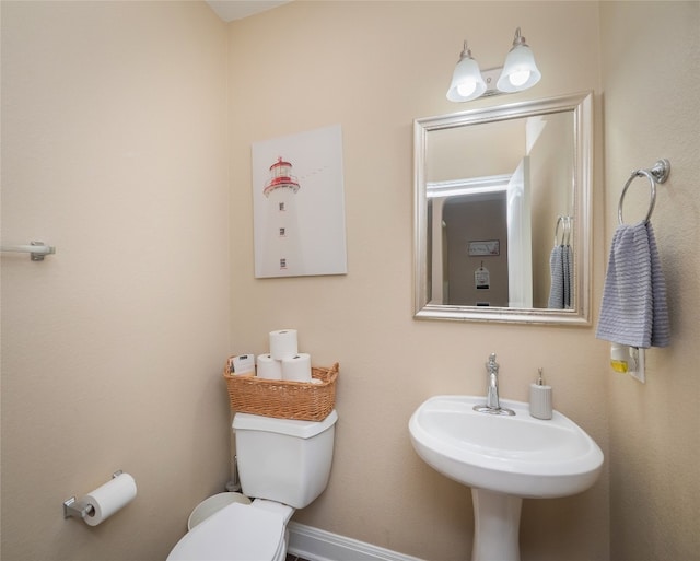 half bathroom with a sink and toilet