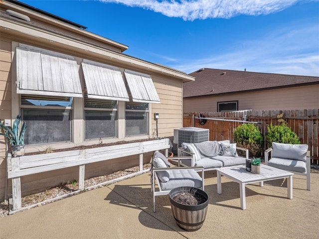 view of patio featuring fence, an outdoor living space, and central air condition unit