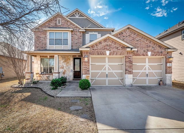 craftsman house featuring brick siding, covered porch, a garage, stone siding, and driveway