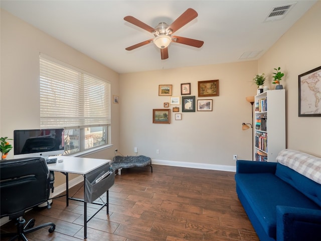 office space with ceiling fan, dark wood-type flooring, visible vents, and baseboards