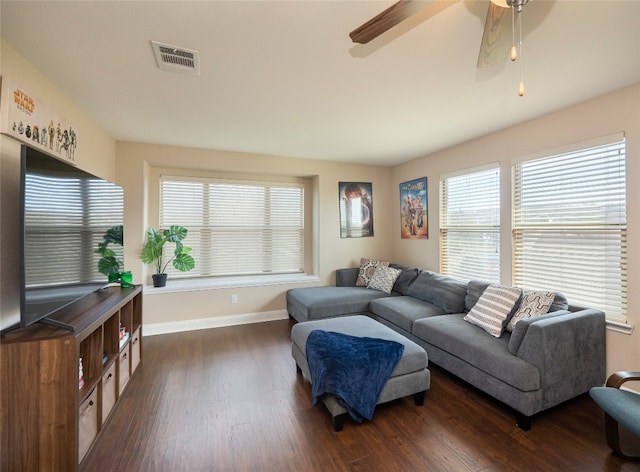 living room featuring baseboards, visible vents, ceiling fan, and dark wood-type flooring