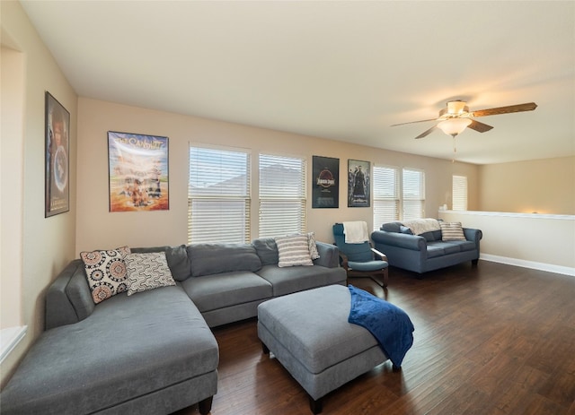 living area with dark wood-style floors, ceiling fan, and baseboards