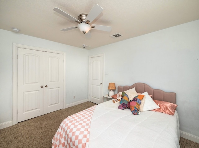 carpeted bedroom with baseboards, visible vents, ceiling fan, and a closet