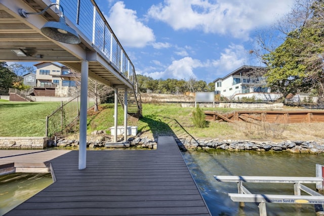 dock area featuring stairway and a yard