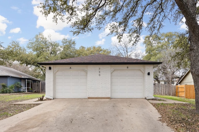 detached garage featuring fence