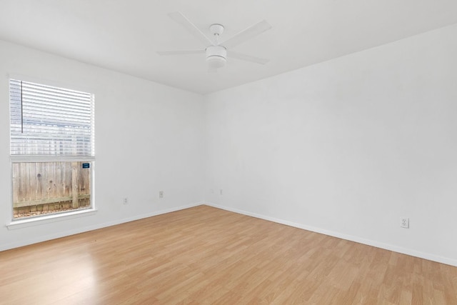 unfurnished room with light wood-style flooring, baseboards, and ceiling fan