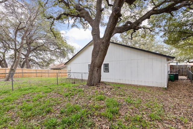 view of side of home with fence