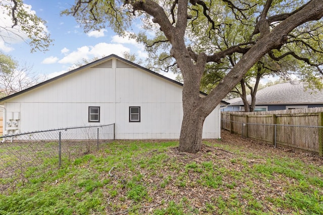 view of side of property featuring fence