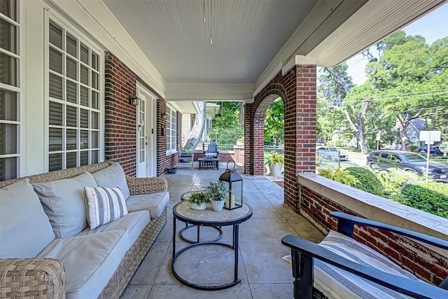 view of patio featuring a porch and an outdoor living space