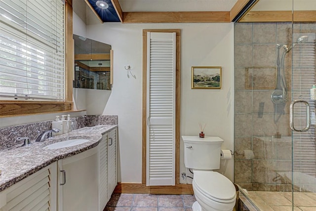 full bathroom featuring toilet, a stall shower, tile patterned flooring, and vanity