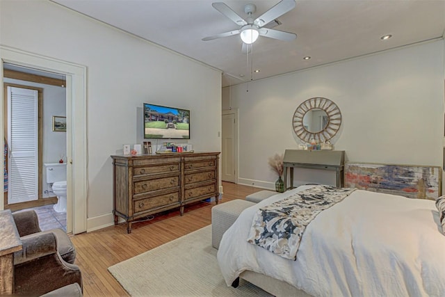 bedroom with recessed lighting, ensuite bathroom, baseboards, and wood finished floors