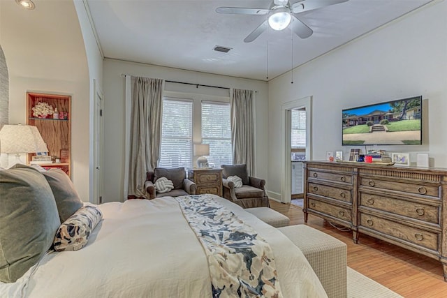 bedroom with a ceiling fan, visible vents, and light wood-style flooring