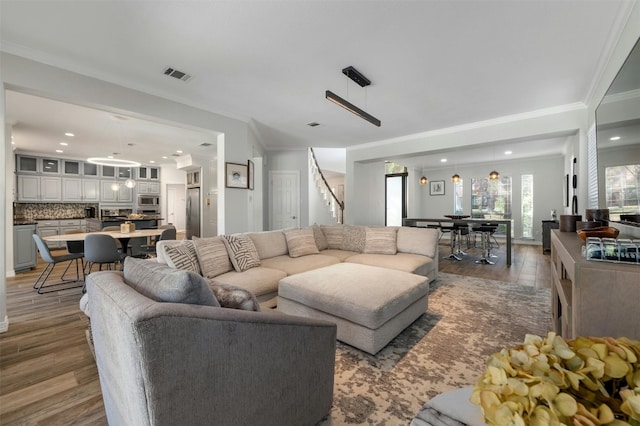9288 Scenic Bluff Dr, Austin, TX 78733 - living room featuring ornamental molding, wood finished floors, stairway, and recessed lighting